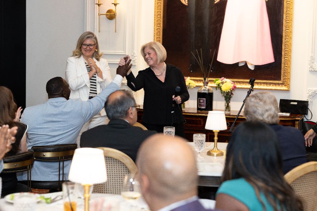 CEOs and business owners celebrating with a high five at a CEO Circle event