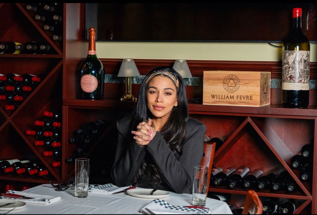Erika Baez-Grimes seated alone at a table during a Private CEO Roundtable
